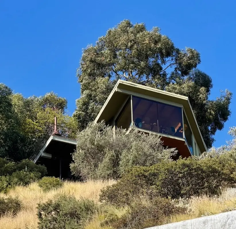 view of the Bosch house nestled in the West Hollywood Hills, featuring mid-century stilt architecture with panoramic Los Angeles city views