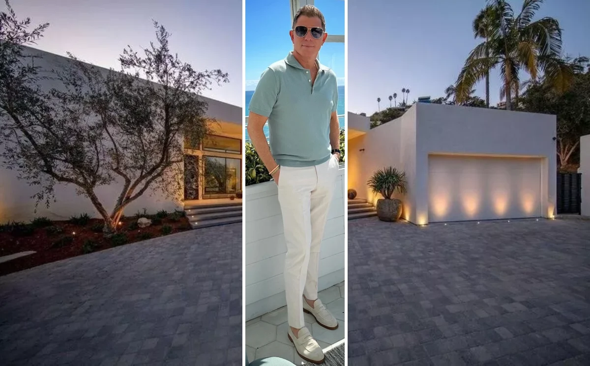 Bobby Flay standing in his stylish Tribeca loft with vintage De Sede sectional sofa and dramatic milk glass chandelier during Architectural Digest Open Door tour